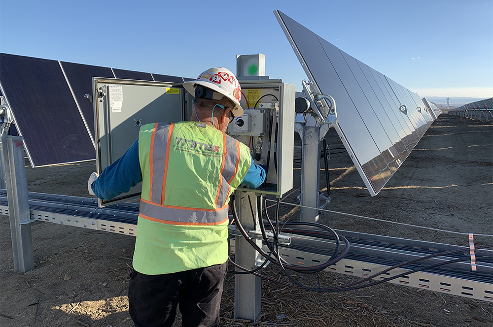 Trimax technician working inside a panel at the solar field photo