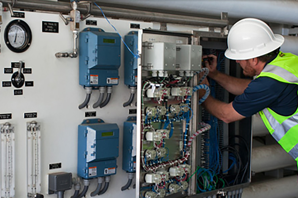 Person working inside a panel onsite